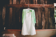 My wedding dress with my cute green cardigan! I bought all of my bridal party a vintage hanger to hang their dresses on.